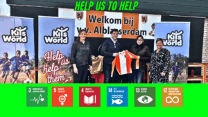 A representative holding a donated football jersey in front of Kits for the World banners, promoting the initiative's mission to support sustainability and empower underprivileged communities through sports