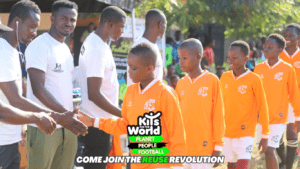 Young football players in orange kits shaking hands with community members, showcasing the impact of football kit donations through Kits for the World, promoting sustainability and global unity